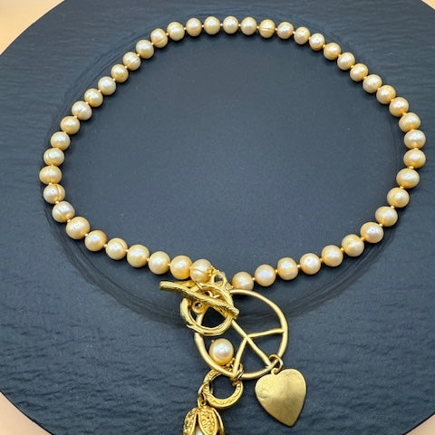 Golden Hue Longer Peasrl Necklace With Gold Charms