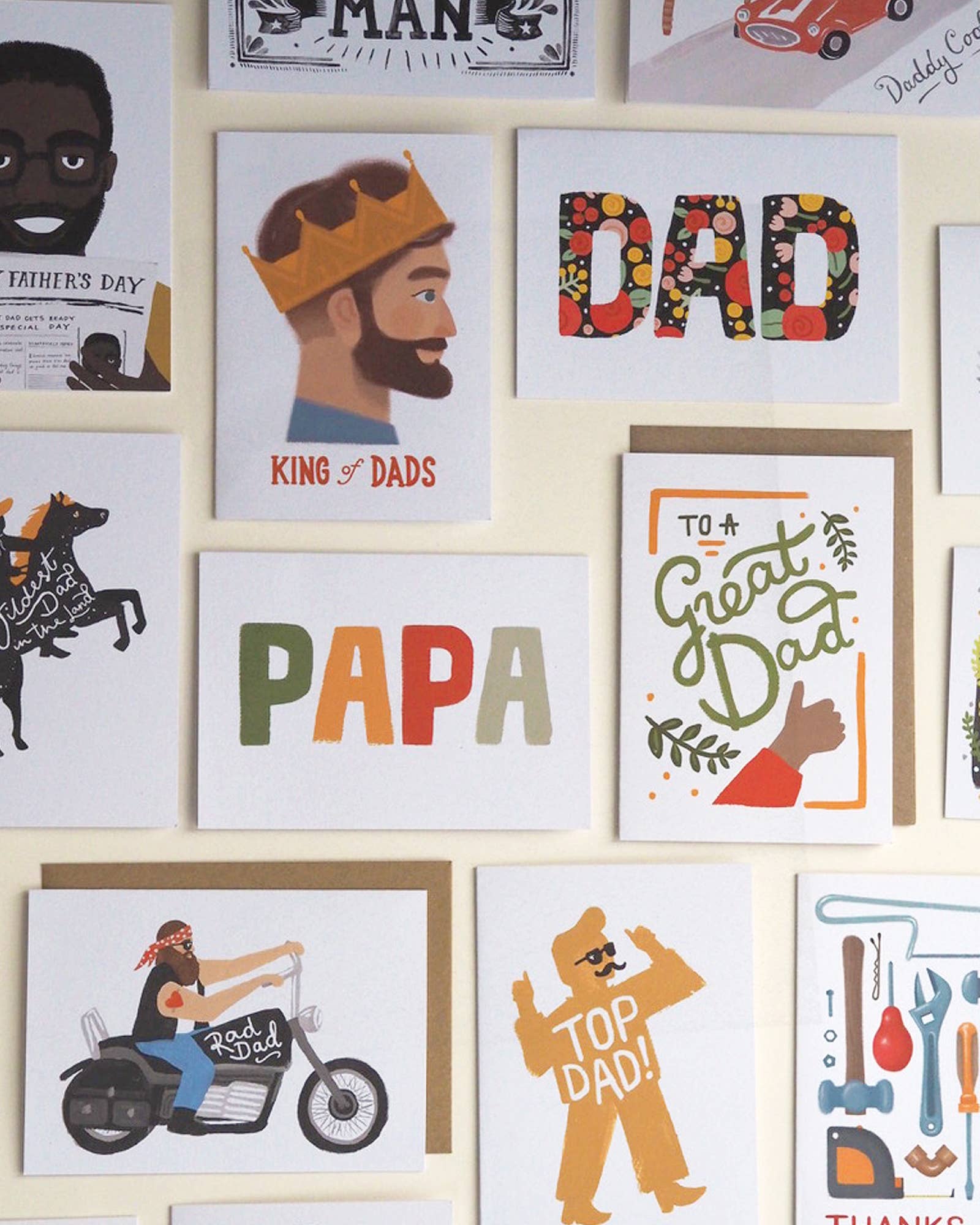 Collection of Father's Day cards with various designs and text on a wall.