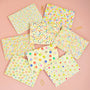 Set of colorful patterned paper sheets on a pink background