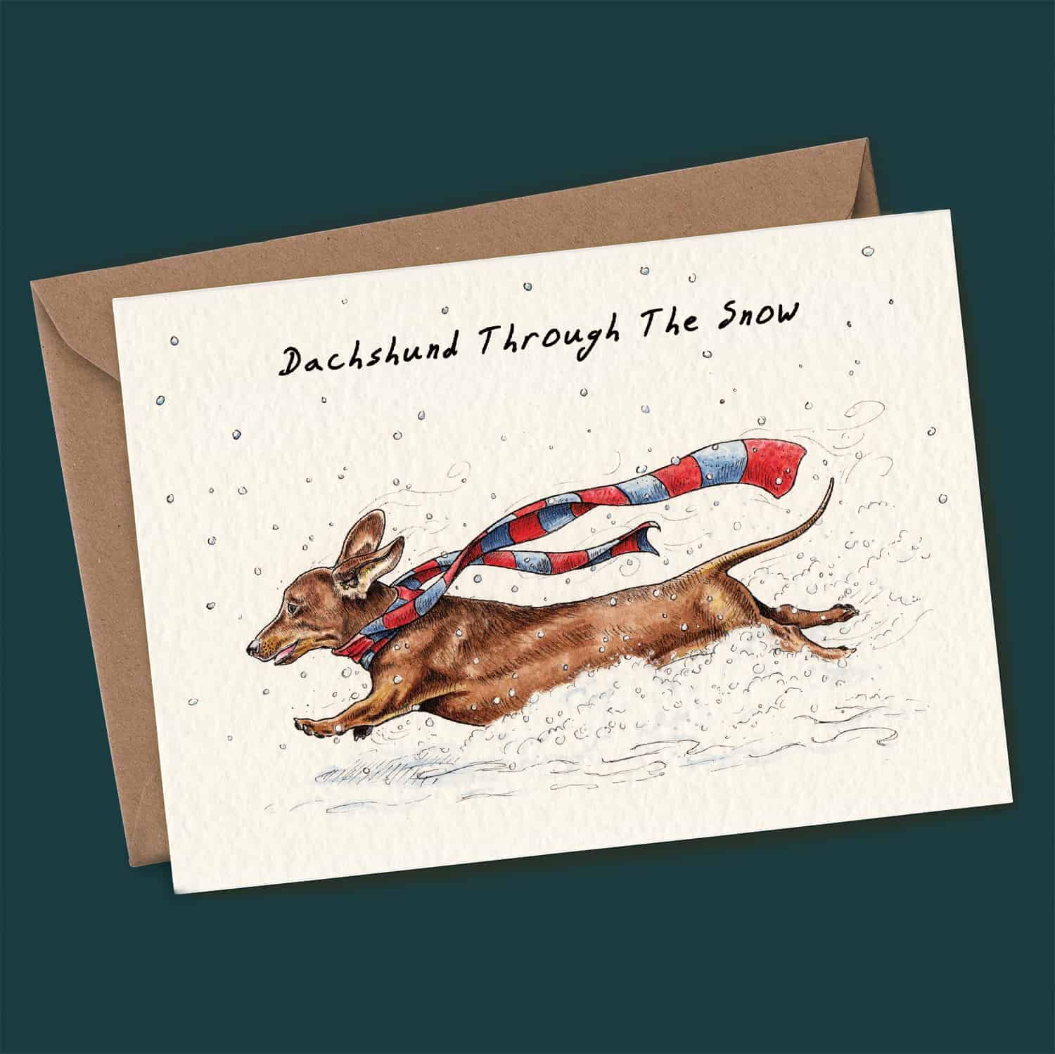 Greeting card with a dachshund illustration and text 'Dachshund Through The Snow' on a dark green background.