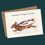 Greeting card with a dachshund illustration and text 'Dachshund Through The Snow' on a dark green background.