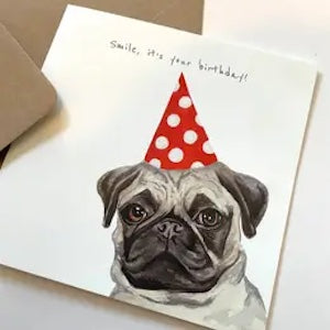 Card with a pug wearing a red party hat and text 'Smile, it's your birthday!' on a white background.