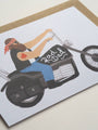 Card with illustration of a woman on a motorcycle wearing a bandana, with 'Rad Dad' text.