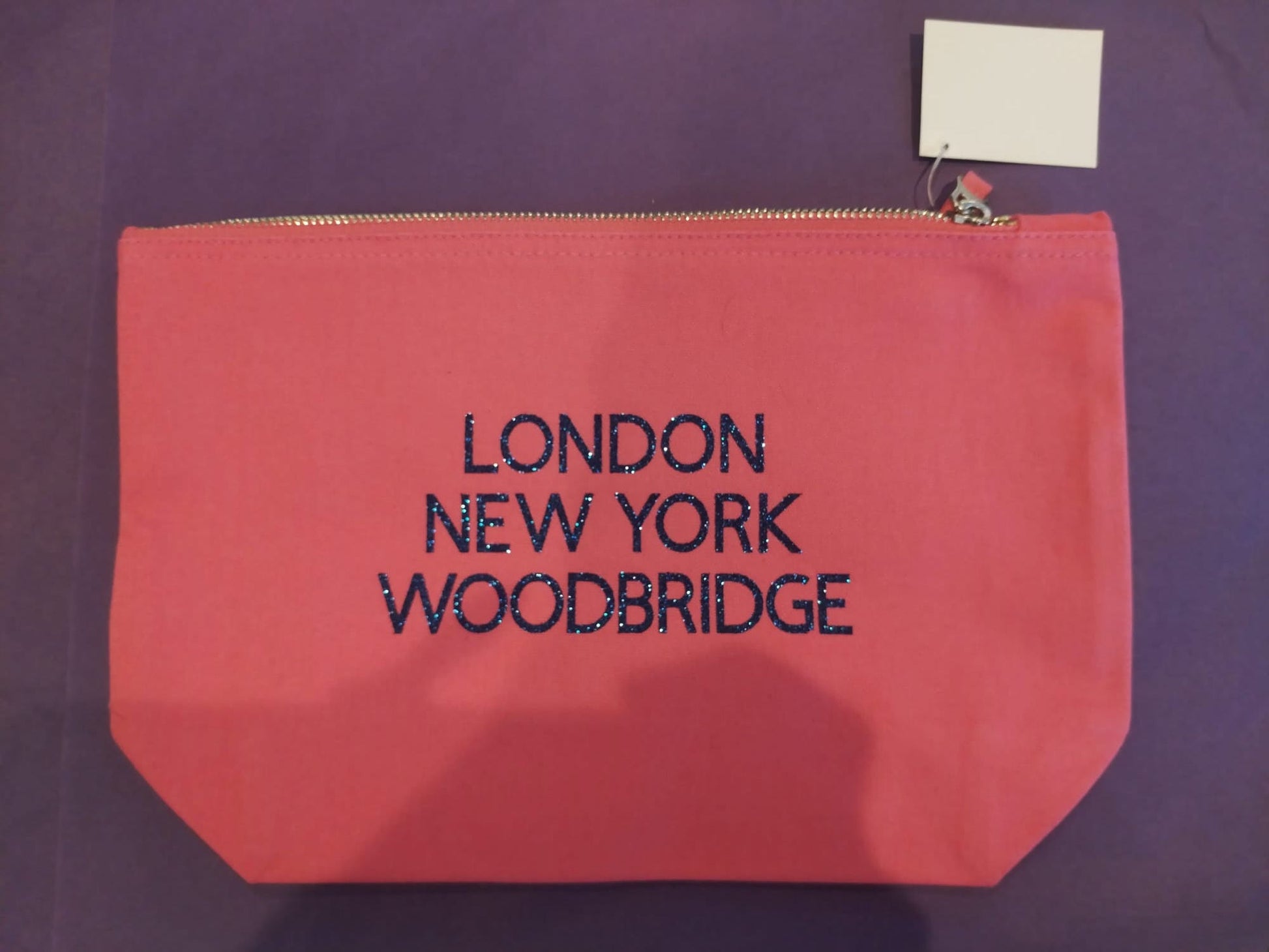 Pink Zippy Blue Text. London New York Woodbridge
