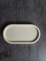 Beige ceramic tray on a dark wooden surface