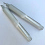 Two metallic cylindrical objects on a white background