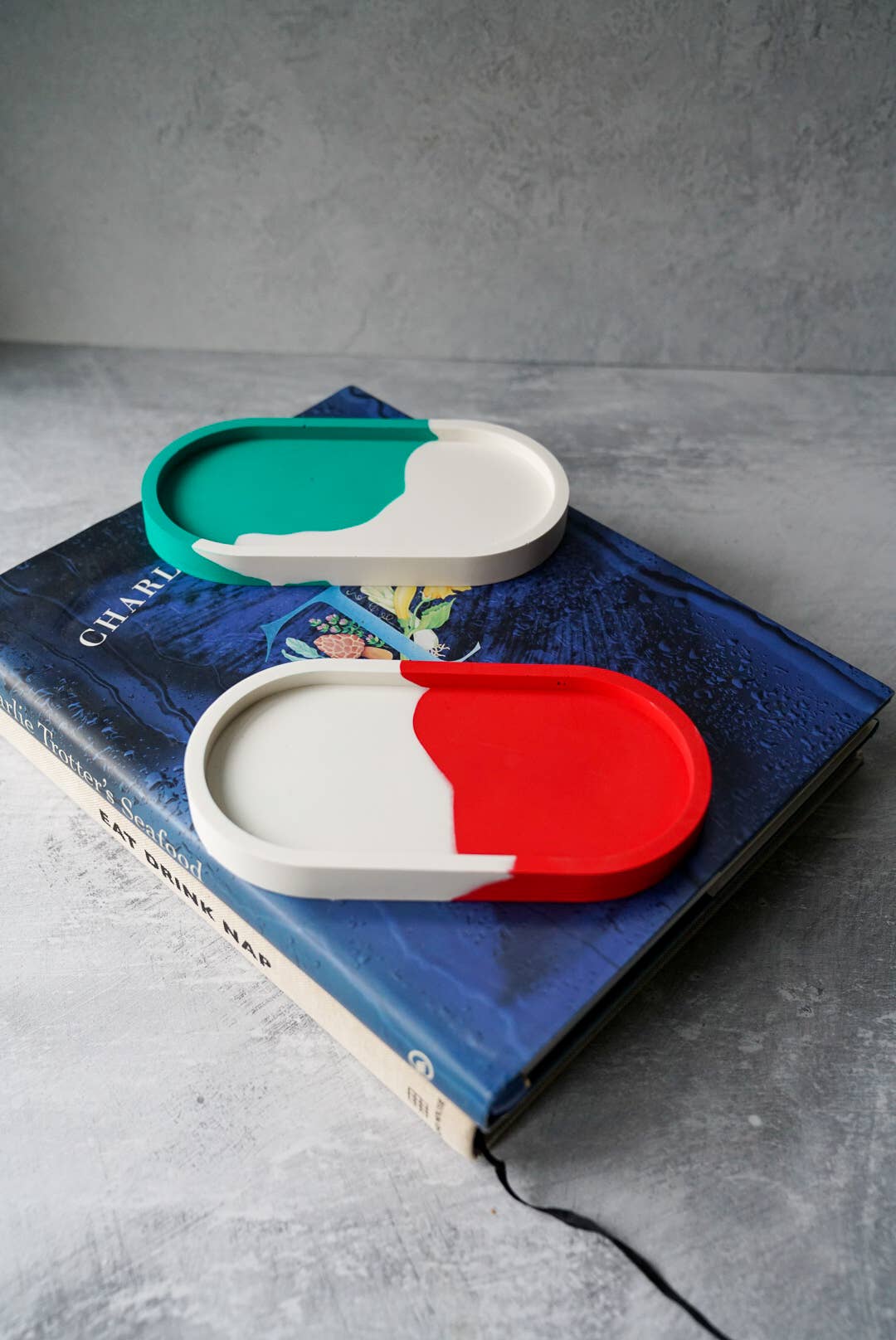 Colorful container lids on a book with a gray background