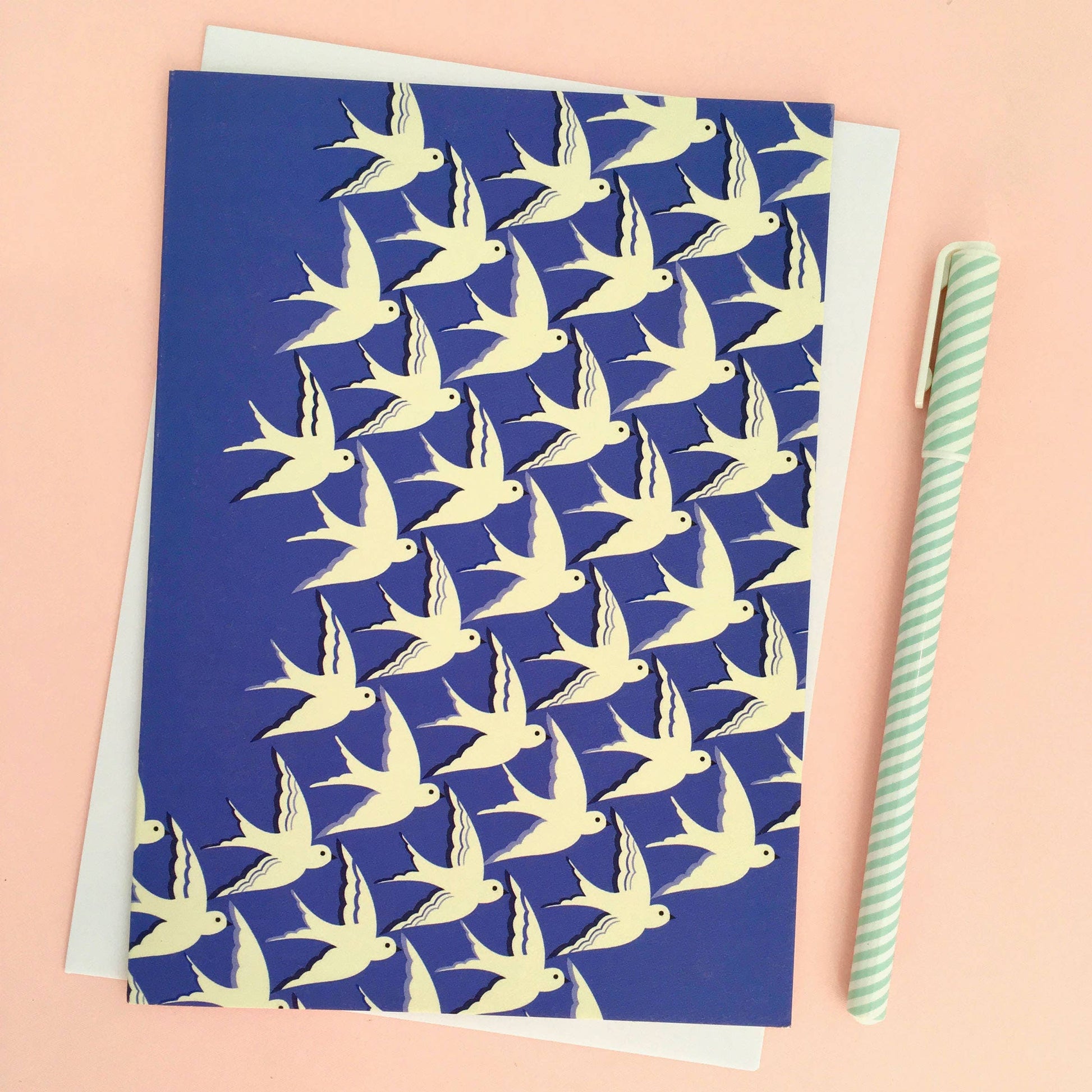 Blue card with yellow bird pattern on a pink background
