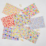 Collection of colorful floral-patterned paper bags on a white background