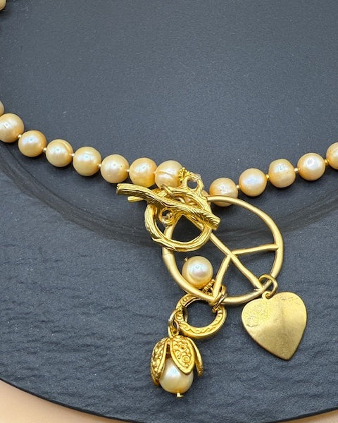 Golden Hue Longer Peasrl Necklace With Gold Charms