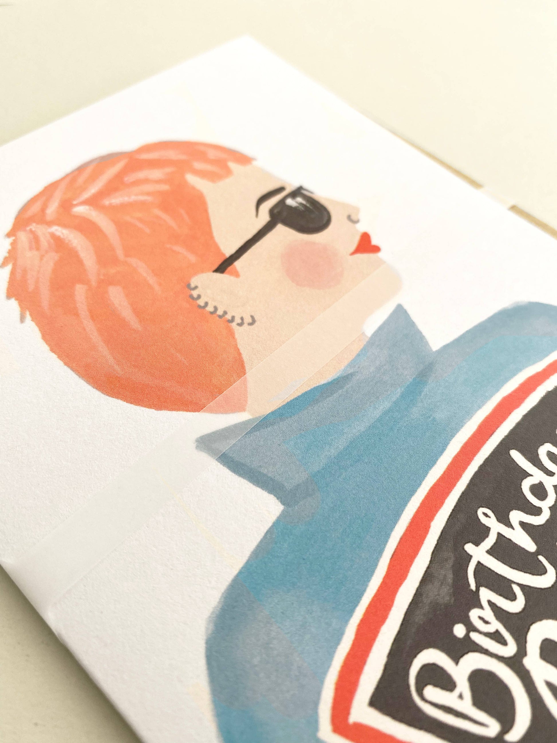 Illustration of a person with sunglasses and a 'Birthday' card on a white background