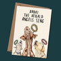 Greeting card with dogs and text 'Bark! The Herald Angels Sing' on a dark green background