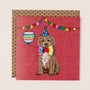 Birthday card with a dog wearing a party hat and bow tie, holding a balloon, on a red background.