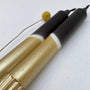 Two pens with gold and black design on a white background