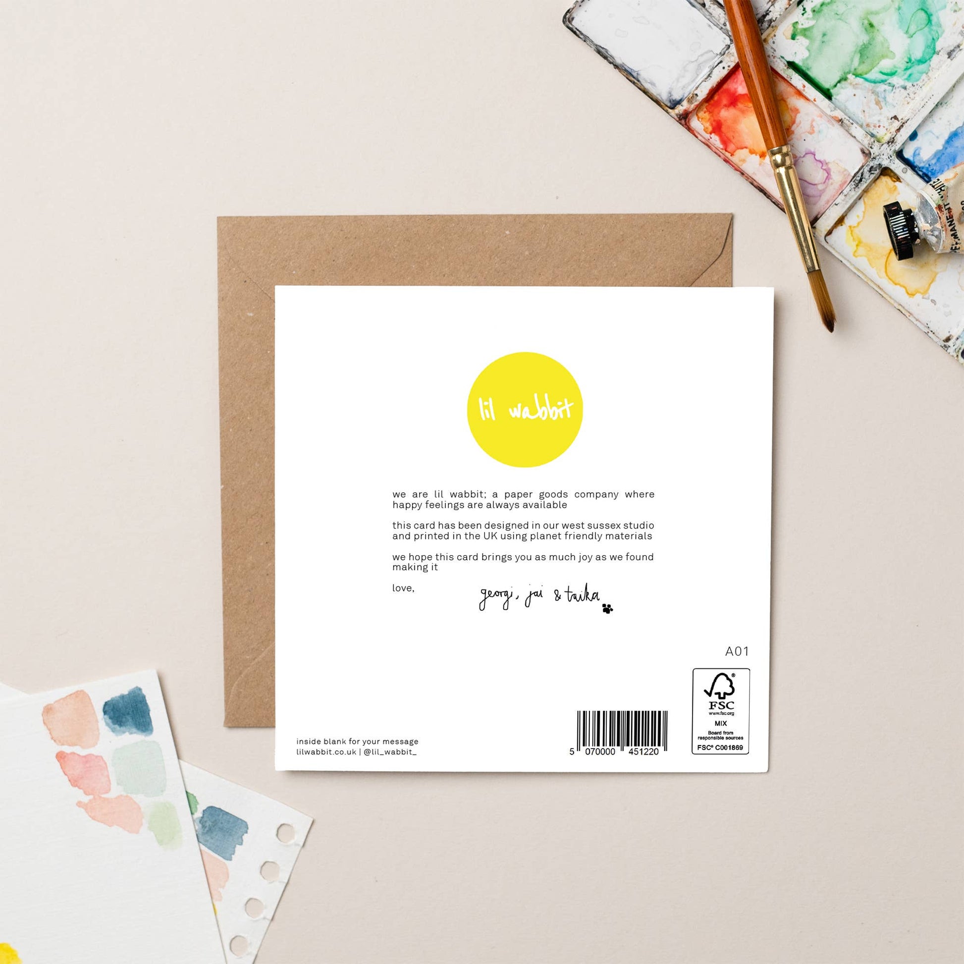 Back of a card with a yellow dot logo and text on a beige background