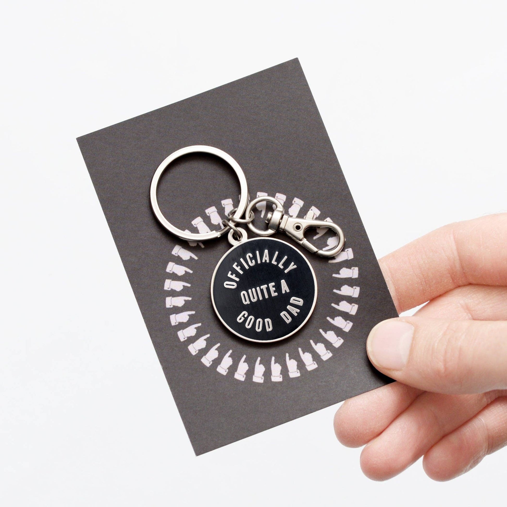 Keychain with 'Officially Quite a Good Dad' text on a card held by a hand