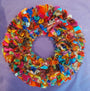 Colorful fabric wreath on a purple background