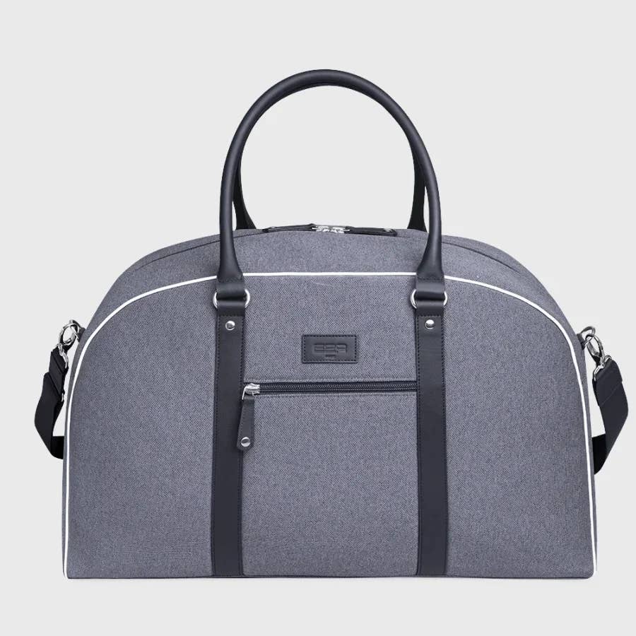 Gray duffel bag with black straps on a light gray background