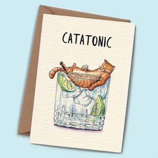 Greeting card with a cat in a cocktail glass and 'Catatonic' text on a light blue background
