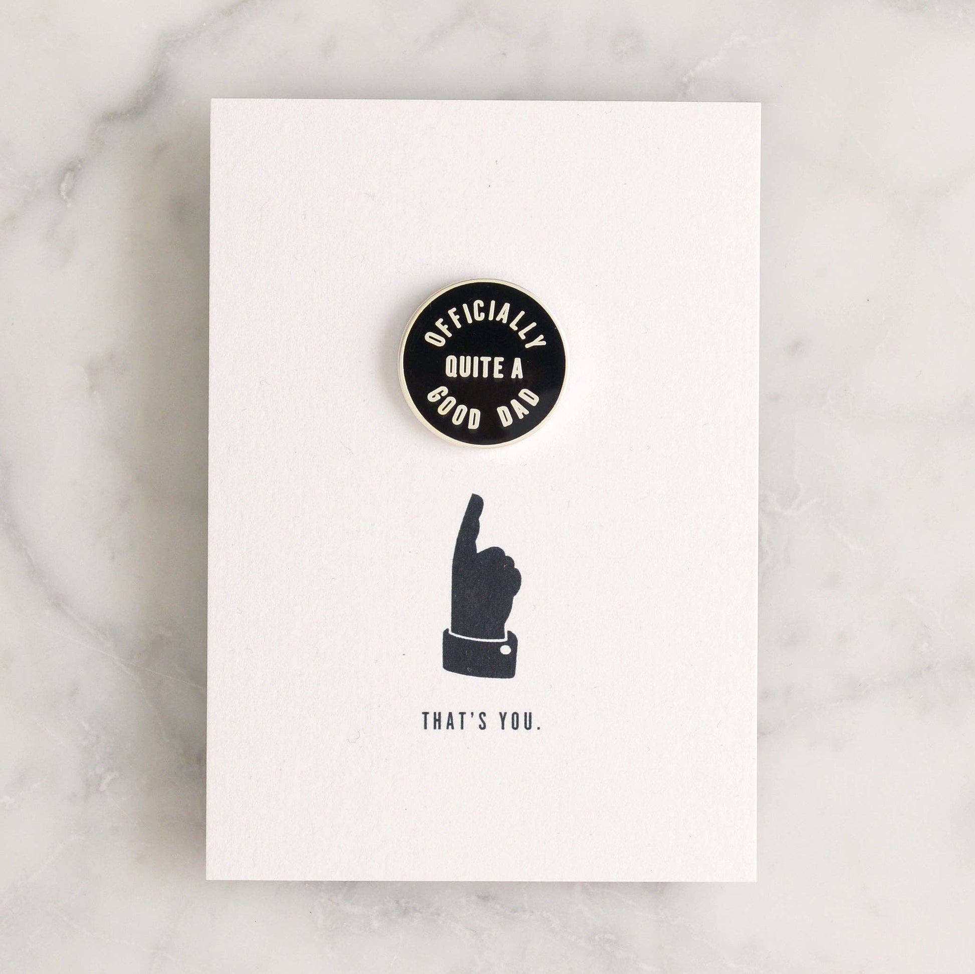 Card with a black and white design featuring a hand gesture and text on a marble surface.