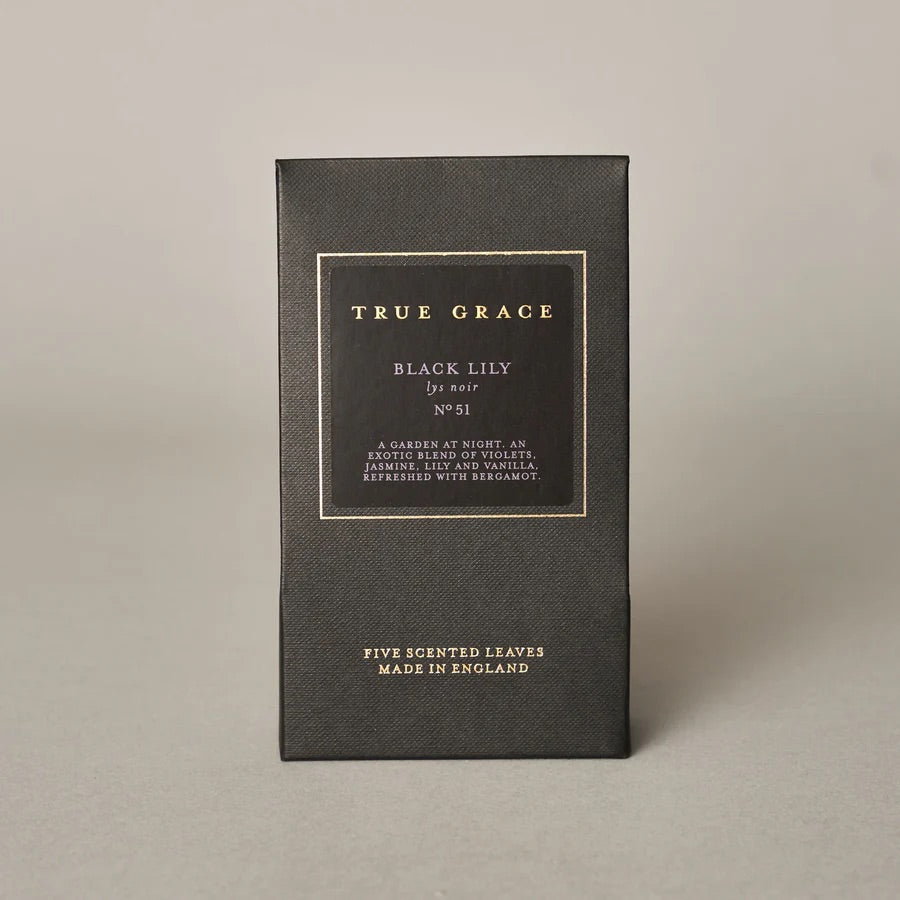 Black box with 'True Grace' branding on a beige background