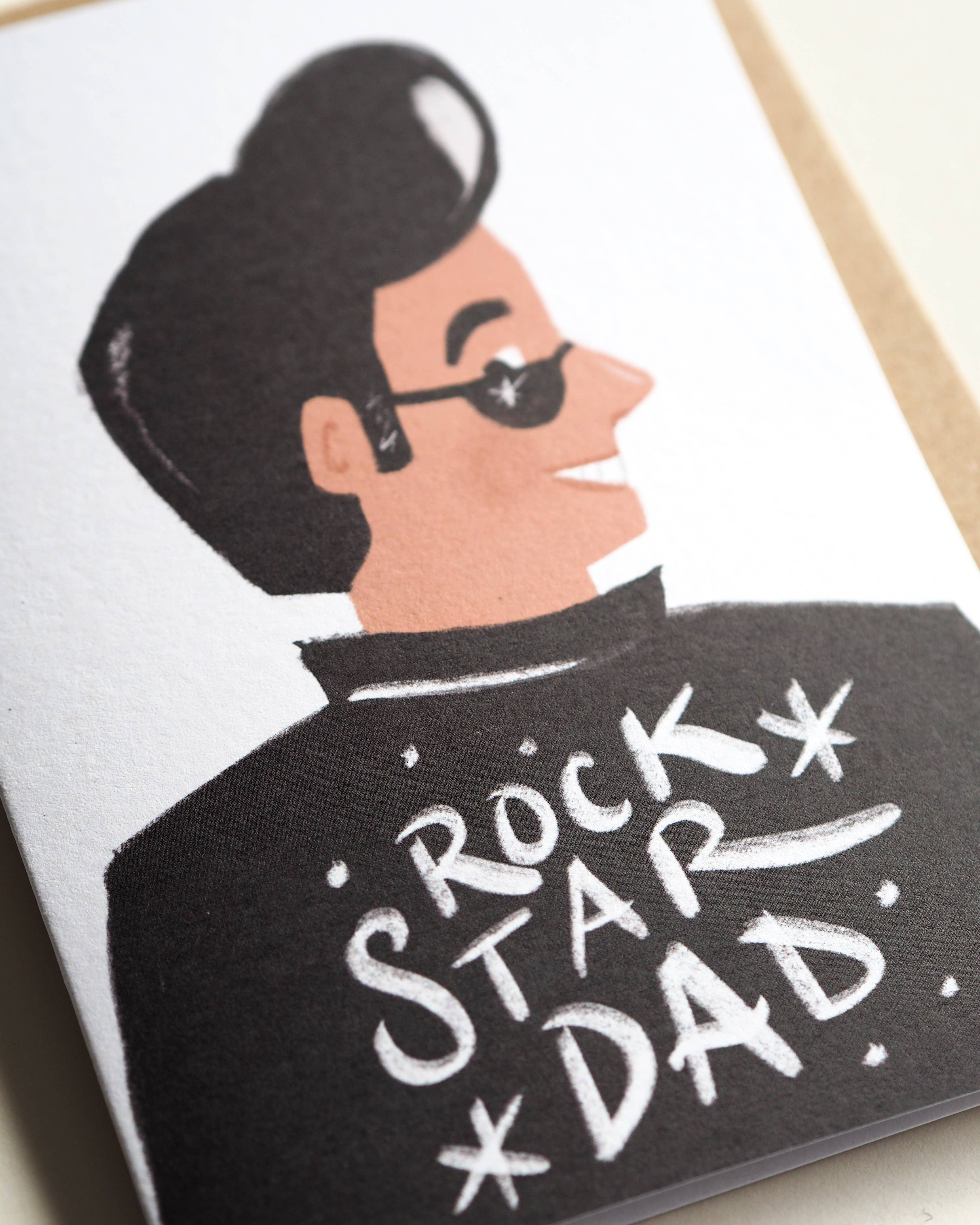 Card with illustration of a man wearing sunglasses and a jacket with 'Rock Star Dad' text.