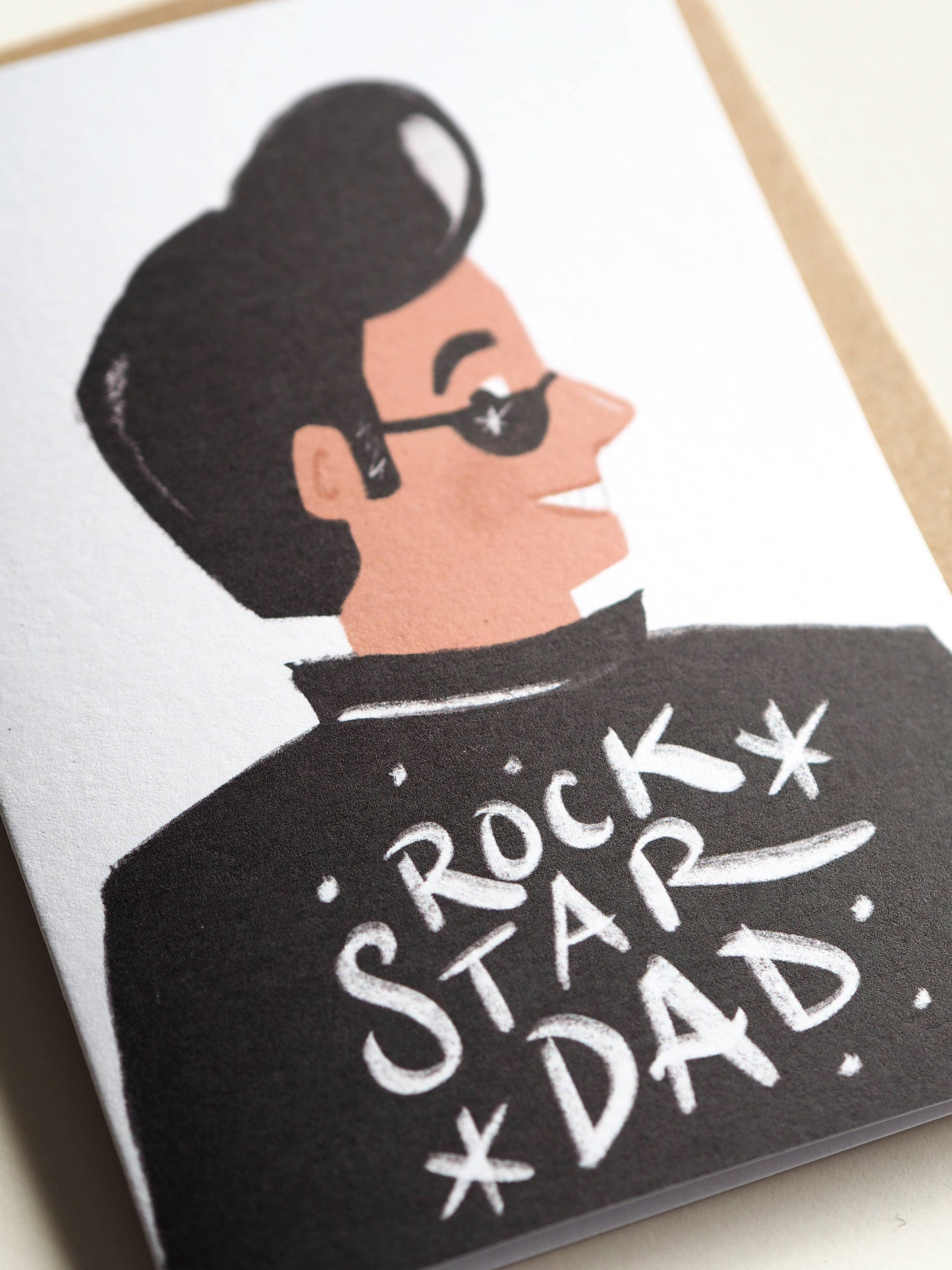 Card with illustration of a man wearing sunglasses and a jacket with 'Rock Star Dad' text.