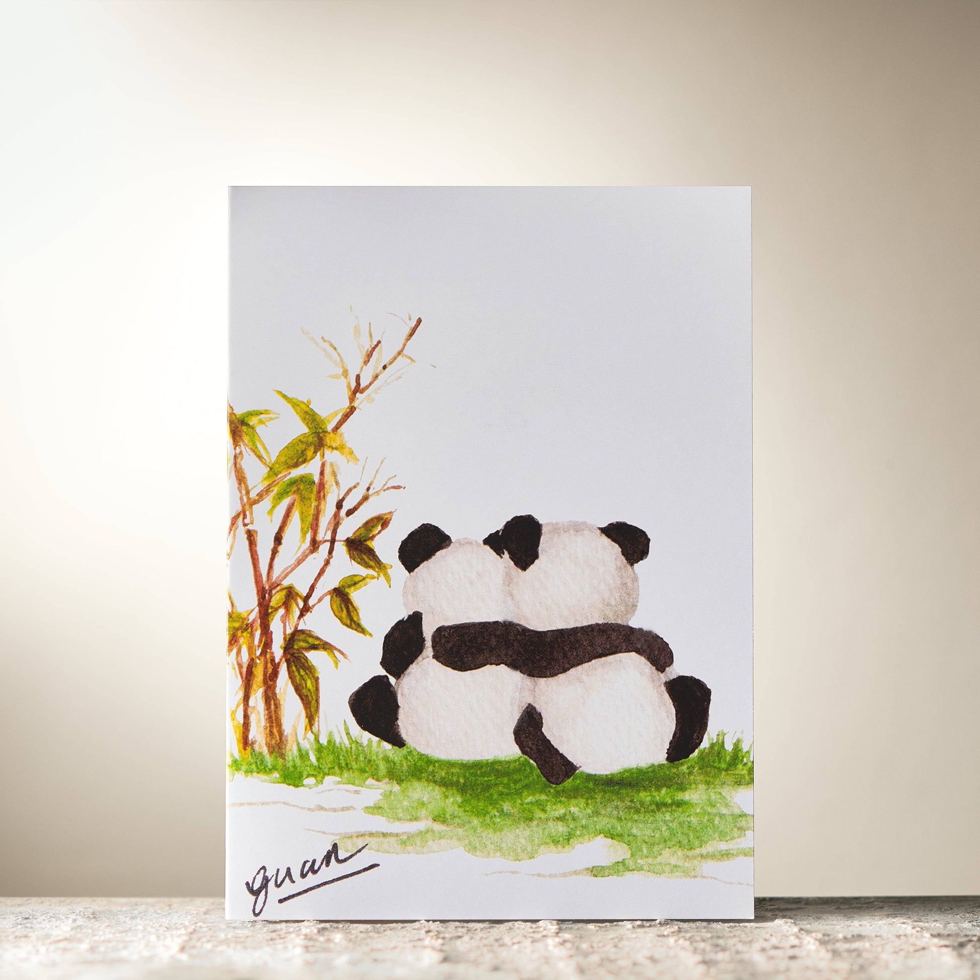 Card with a panda illustration and bamboo on a light background