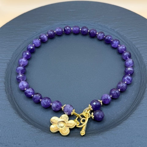 Purple faceted beads with gold flower necklace