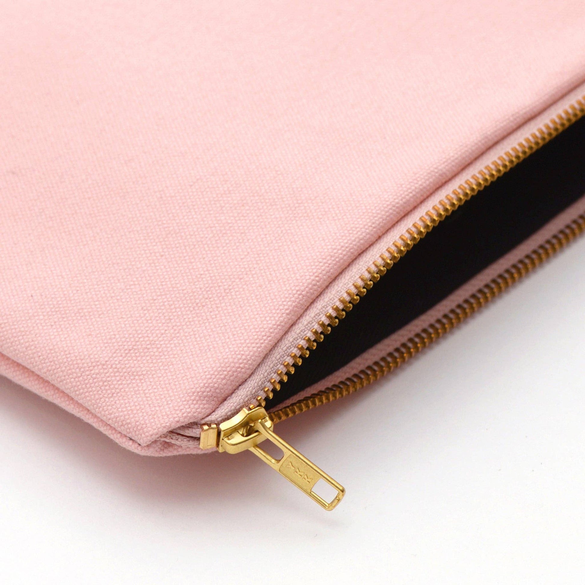 Pink pouch with gold zipper on a white background