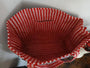 Red and white striped fabric basket on a white background