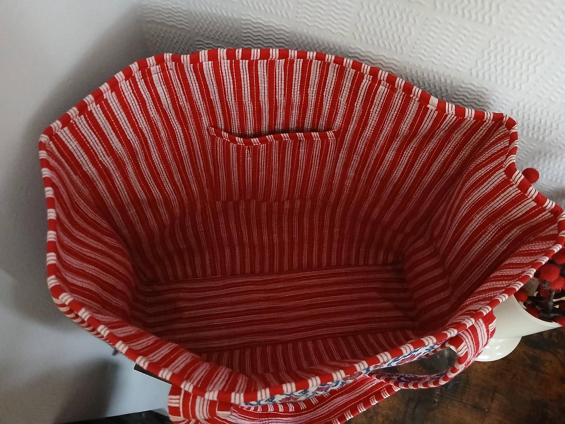 Red and white striped fabric basket on a white background