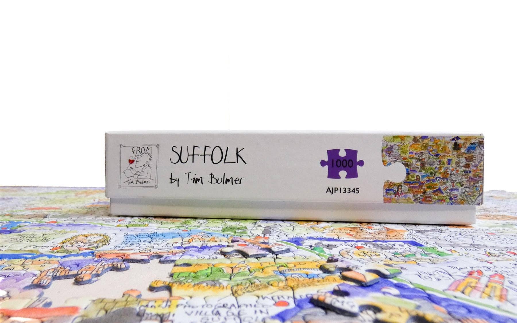 Jigsaw puzzle box labeled 'Suffolk by Tim Burton' with a partially completed puzzle on a white background.