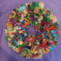 Colorful fabric wreath on a purple background