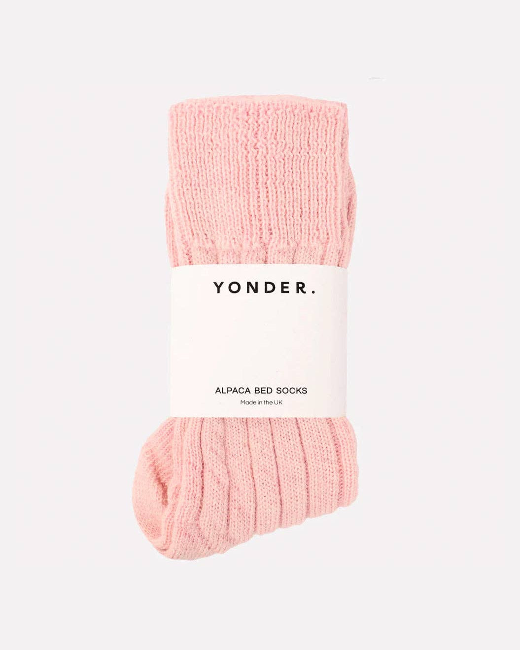 Pink bed socks with 'Yonder' label on a white background