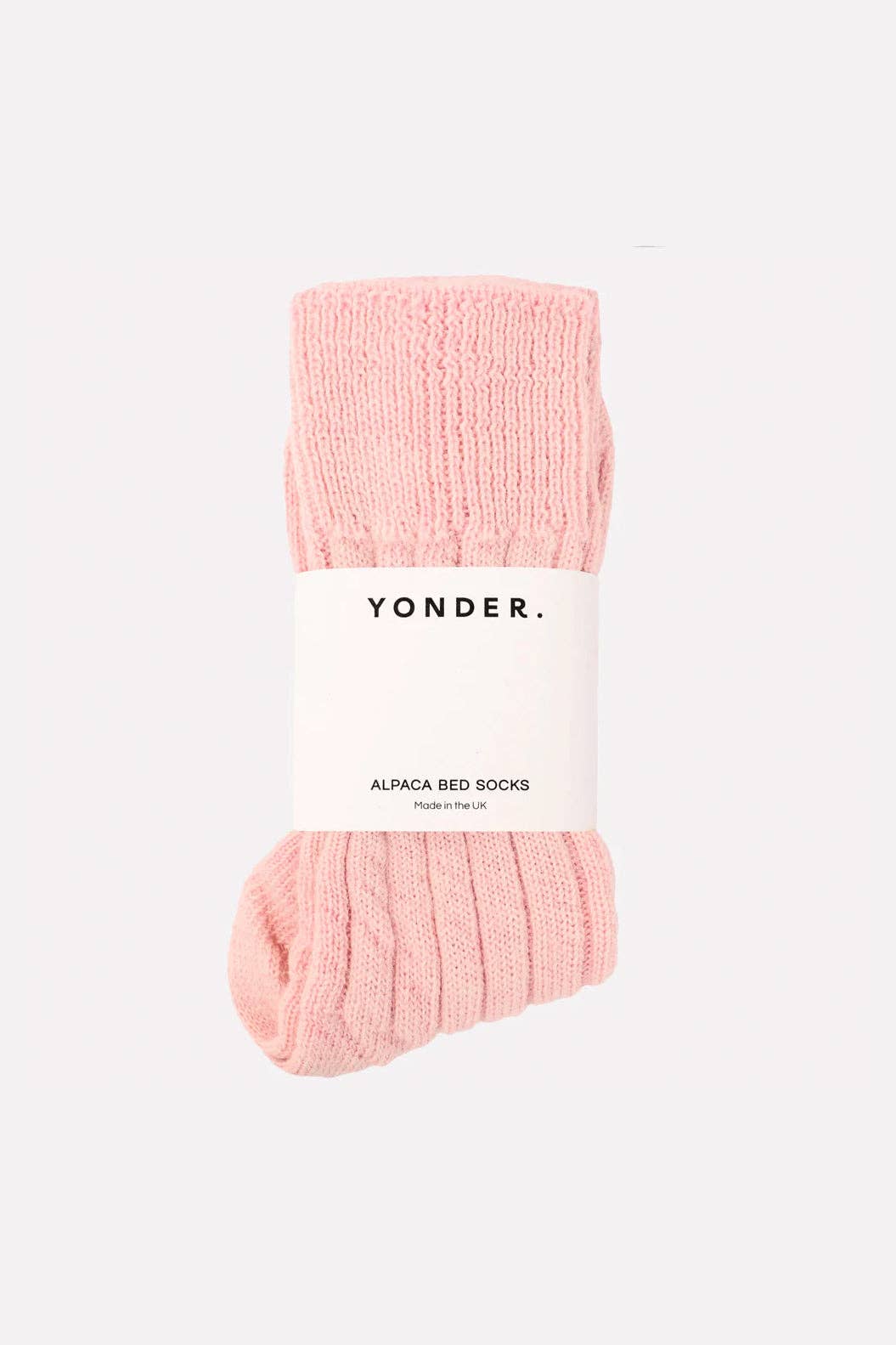 Pink bed socks with 'Yonder' label on a white background