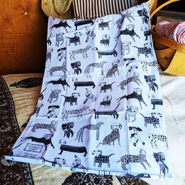 Folded blanket with black and white animal pattern on a wooden surface