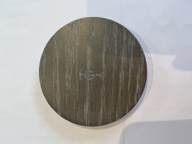 Round wooden coaster with a logo on a white background