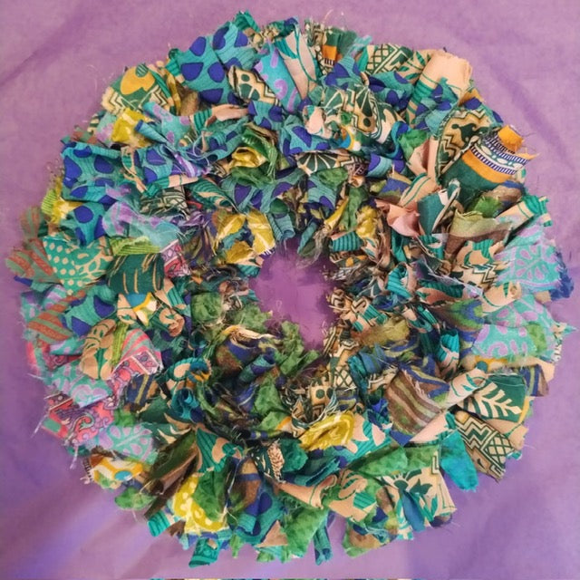 Colorful fabric wreath on a purple background