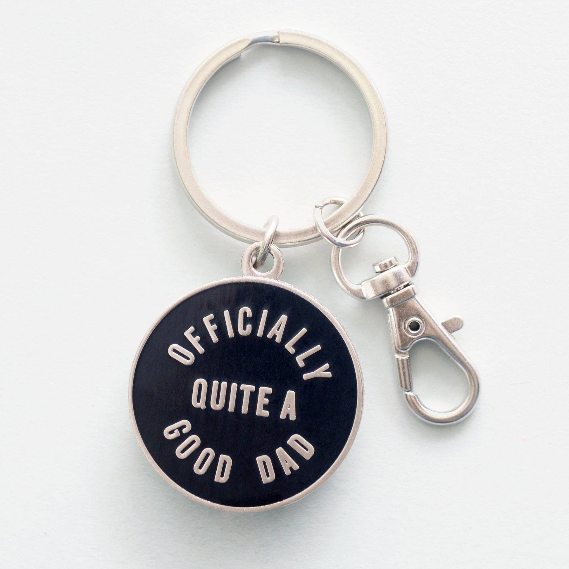 Keychain with 'Officially Quite a Good Dad' text on a white background