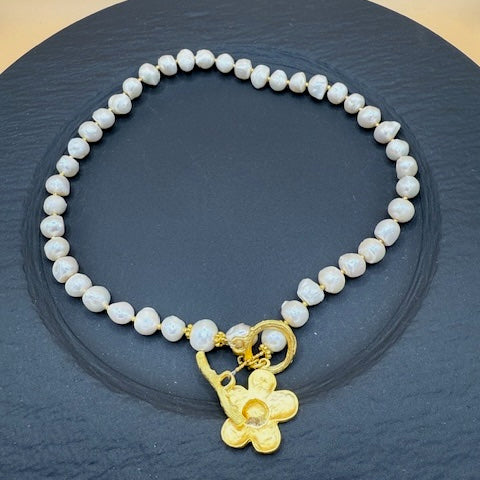Freshwater pearl necklace with gold flower charm