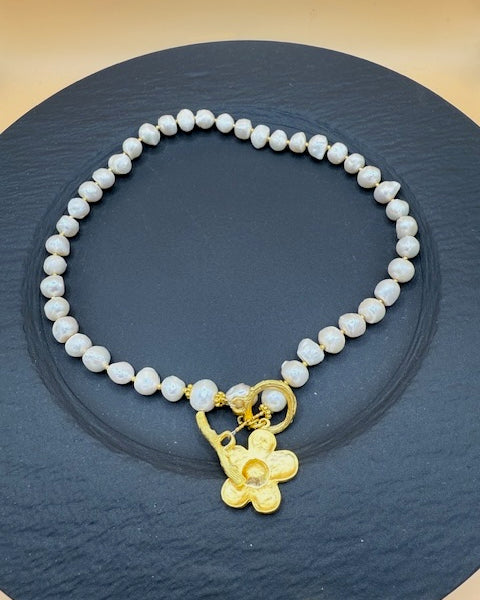 Freshwater pearl necklace with gold flower charm